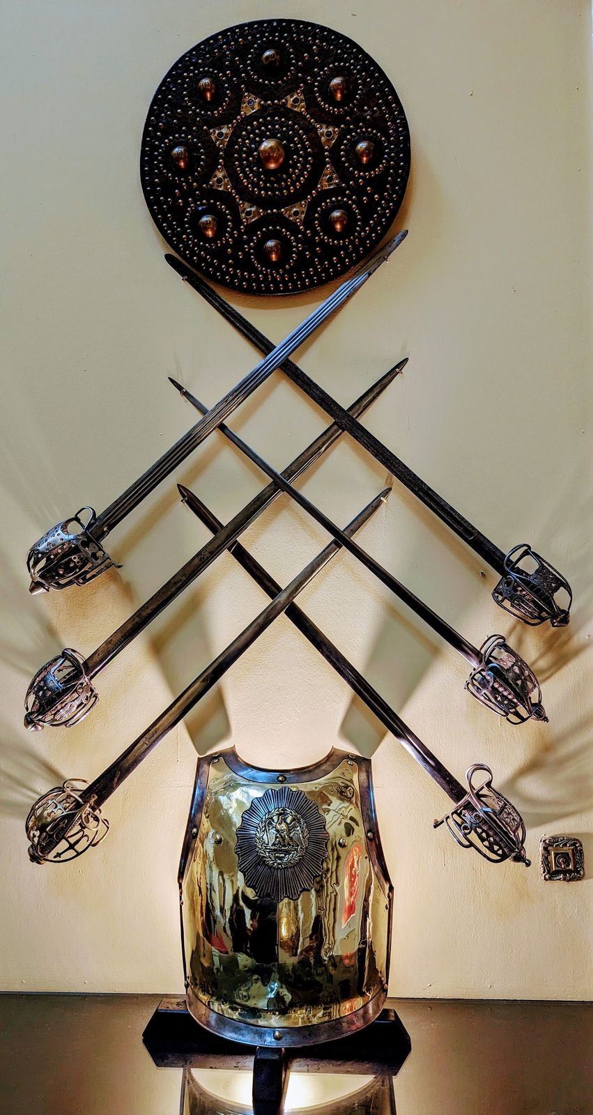 Crossed swords, a targe and a breastplate on the Armoury Hall wall, Inveraray Castle