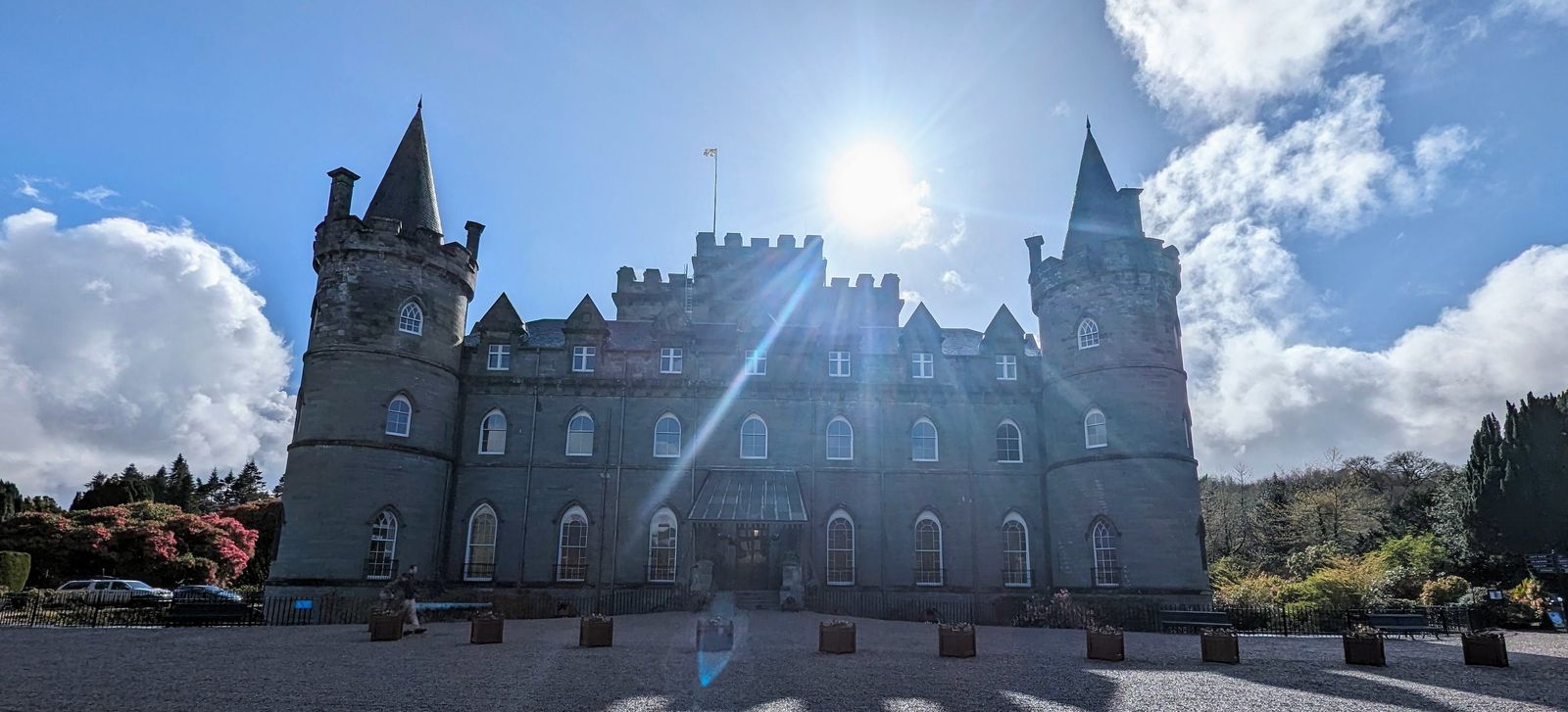 Inveraray Castle with the sun bursting behind its towers