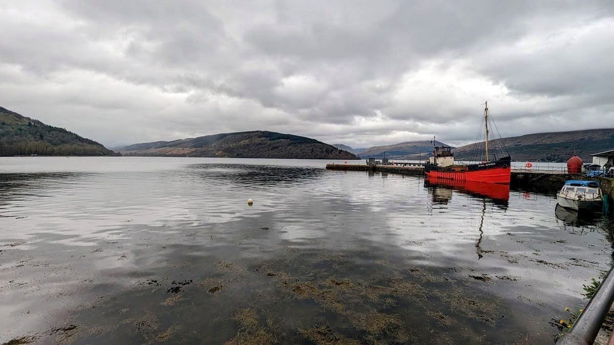 The pier and waterfront at Inveraray on Loch Fyne, hills beyond.