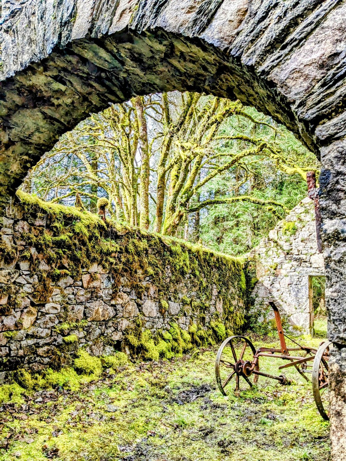 A moss-covered stone arch in the woods above Inveraray