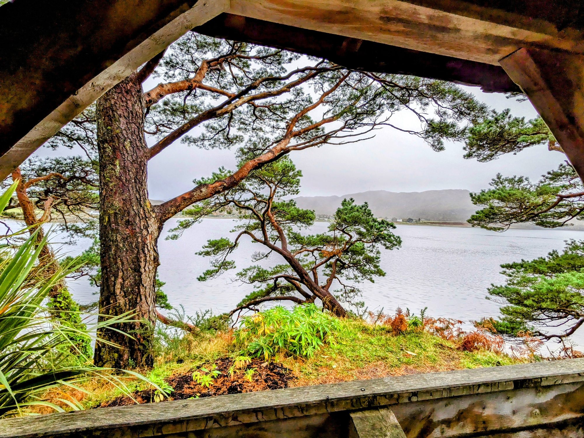 A stone arch framing a view over Loch Ewe from Inverewe Garden.