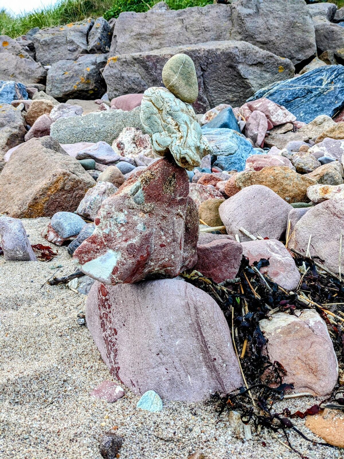 A balanced-stone cairn on the rocky shore at Keil, southern Kintyre.