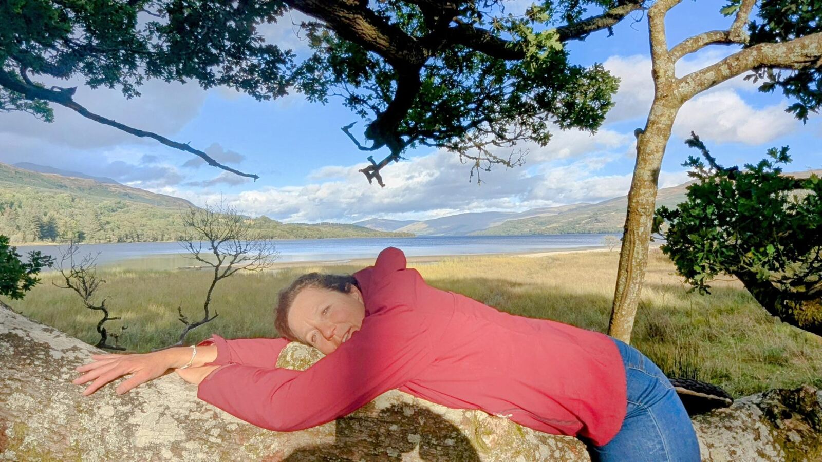 Resting on the grass by the shore of Loch Tay near Killin, under the trees on a bright day.