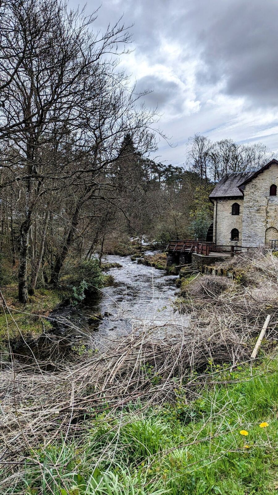The three-storey stone Old Mill building beside the River Dochart at Killin.