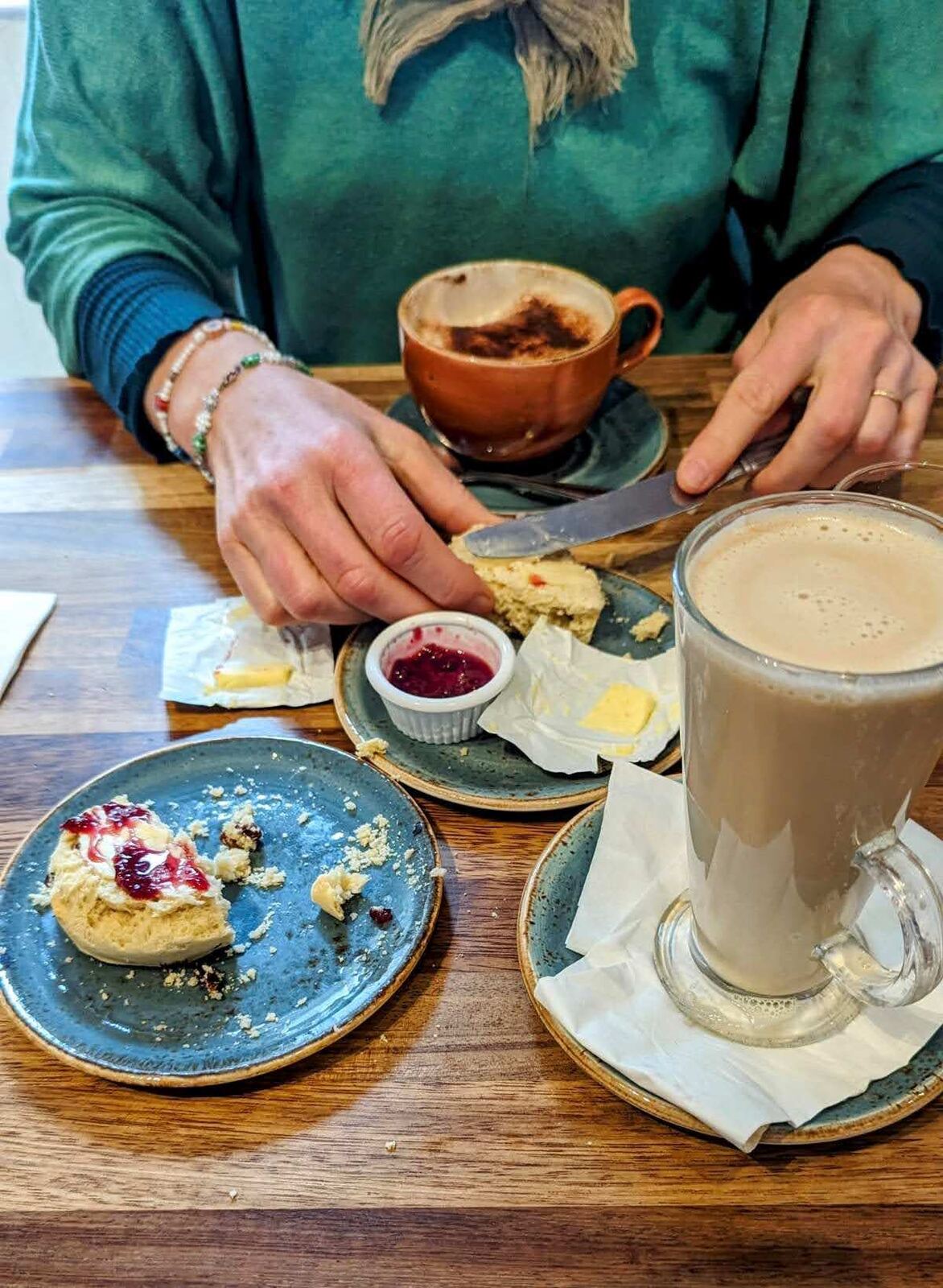 Coffee and scones with jam on a table at a coffee shop in Killin village centre.