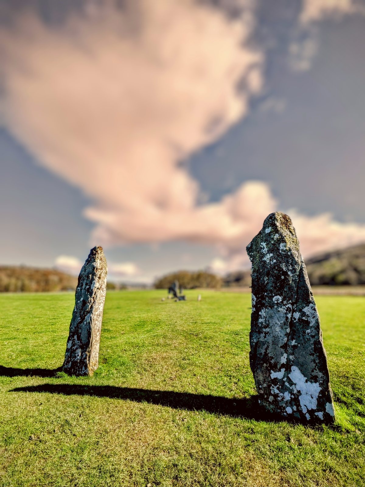 A standing stone beneath dramatic clouds at Nether Largie.