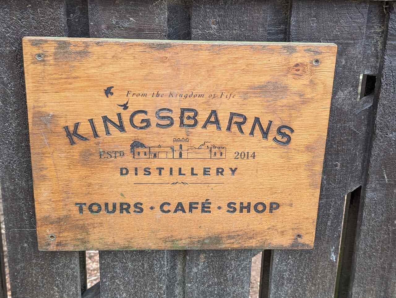 The wooden sign for Kingsbarns Distillery, established 2014, in the East Neuk of Fife.
