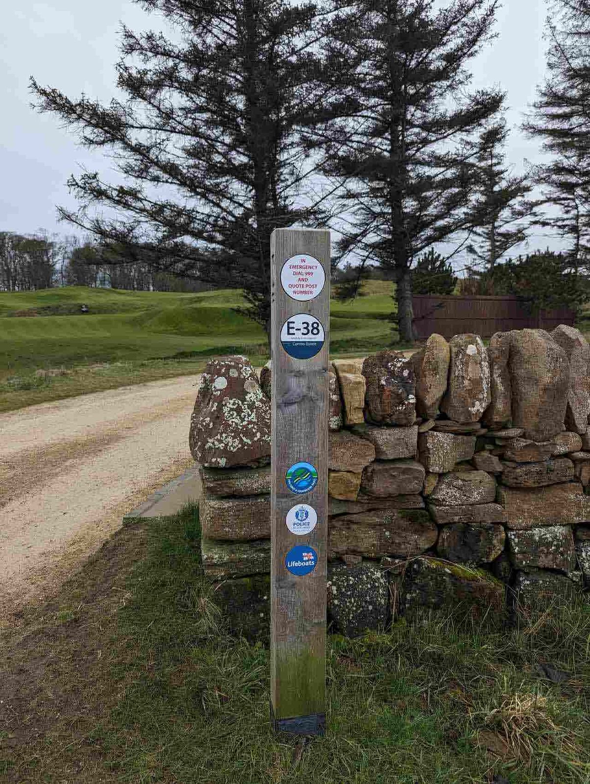 A Fife Coastal Path waymarker where the path crosses Kingsbarns Golf Links by the sea.