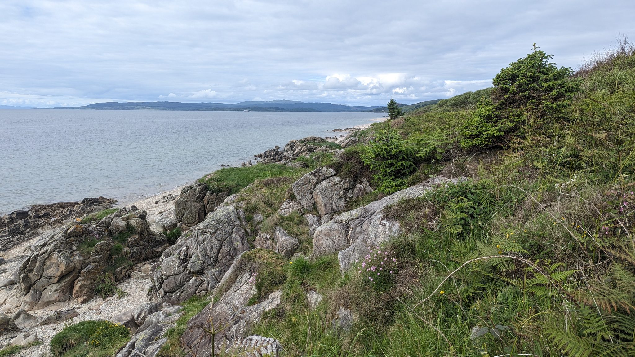 A rocky point on the east Kintyre shore looking across the Kilbrannan Sound to Arran.