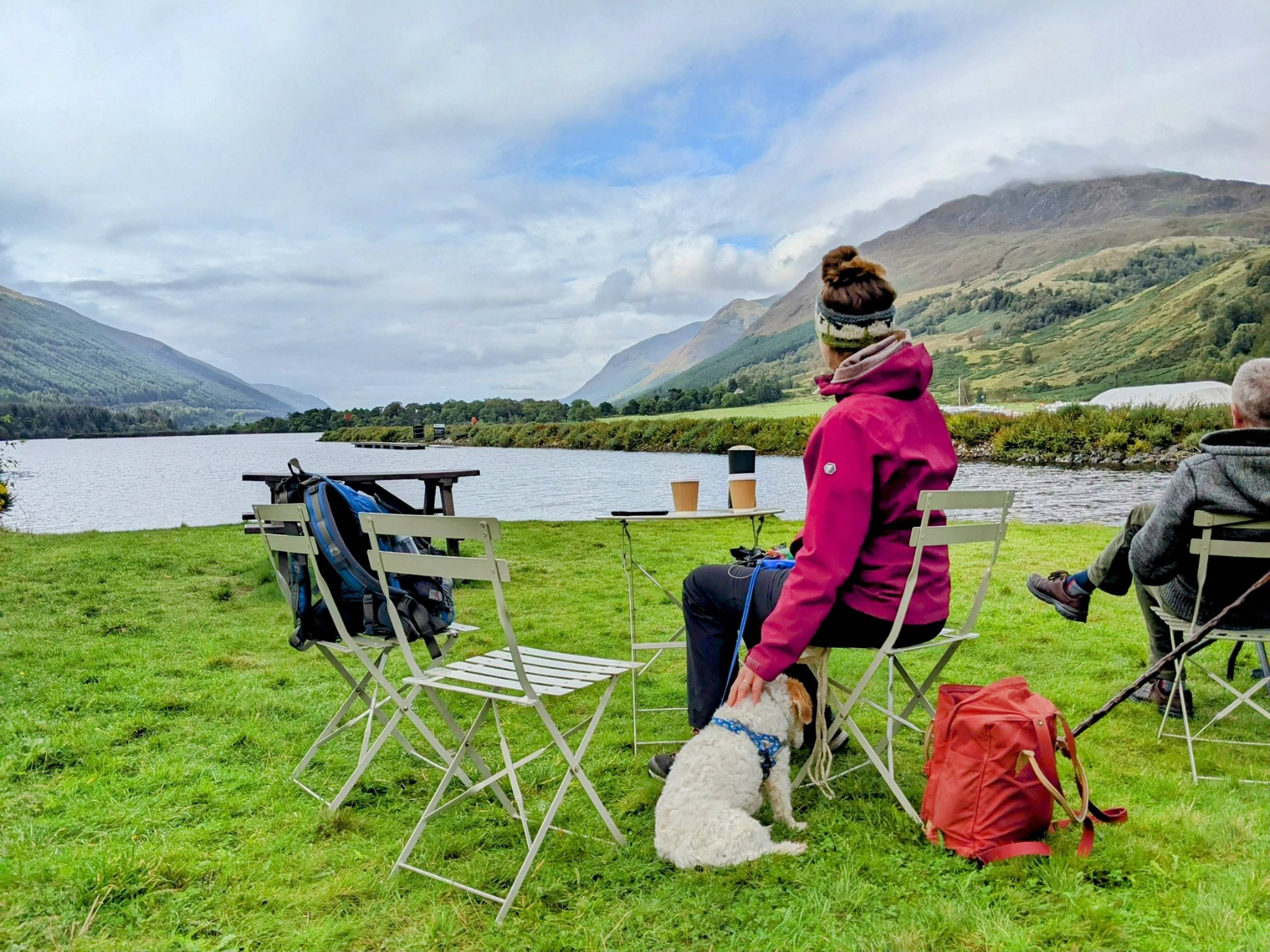 Coffee at the tearoom tables on the grass beside Laggan Locks, looking down Loch Lochy into the Great Glen, with Lillie the dog.