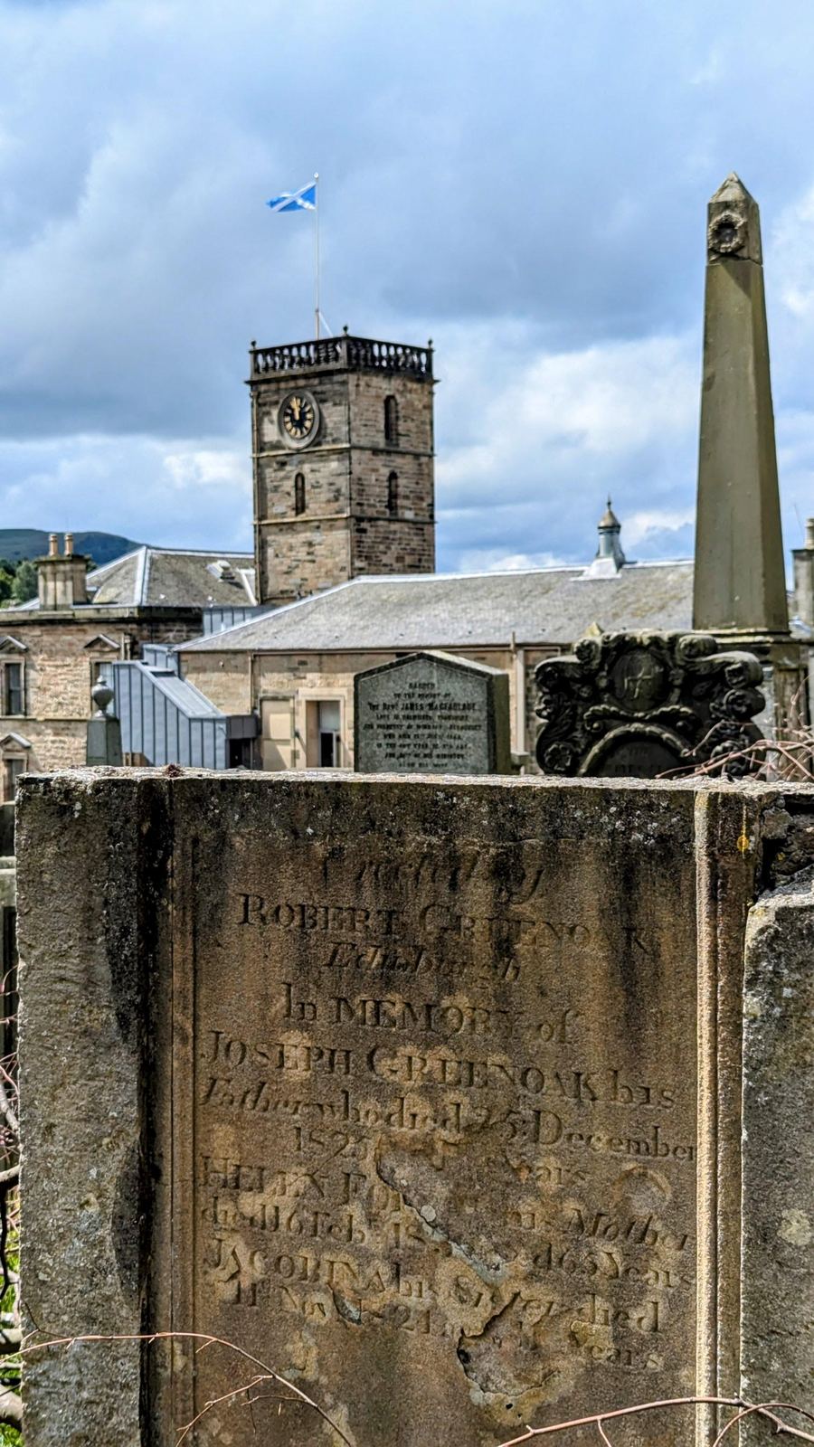 The sandstone tower of St Michael's Church, Linlithgow, topped by a gold-coloured aluminium crown spire.