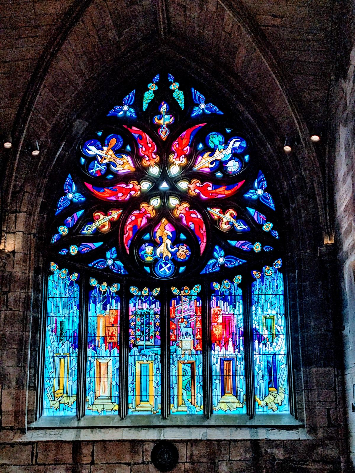 A large, richly coloured stained-glass window in St Michael's Church, Linlithgow.