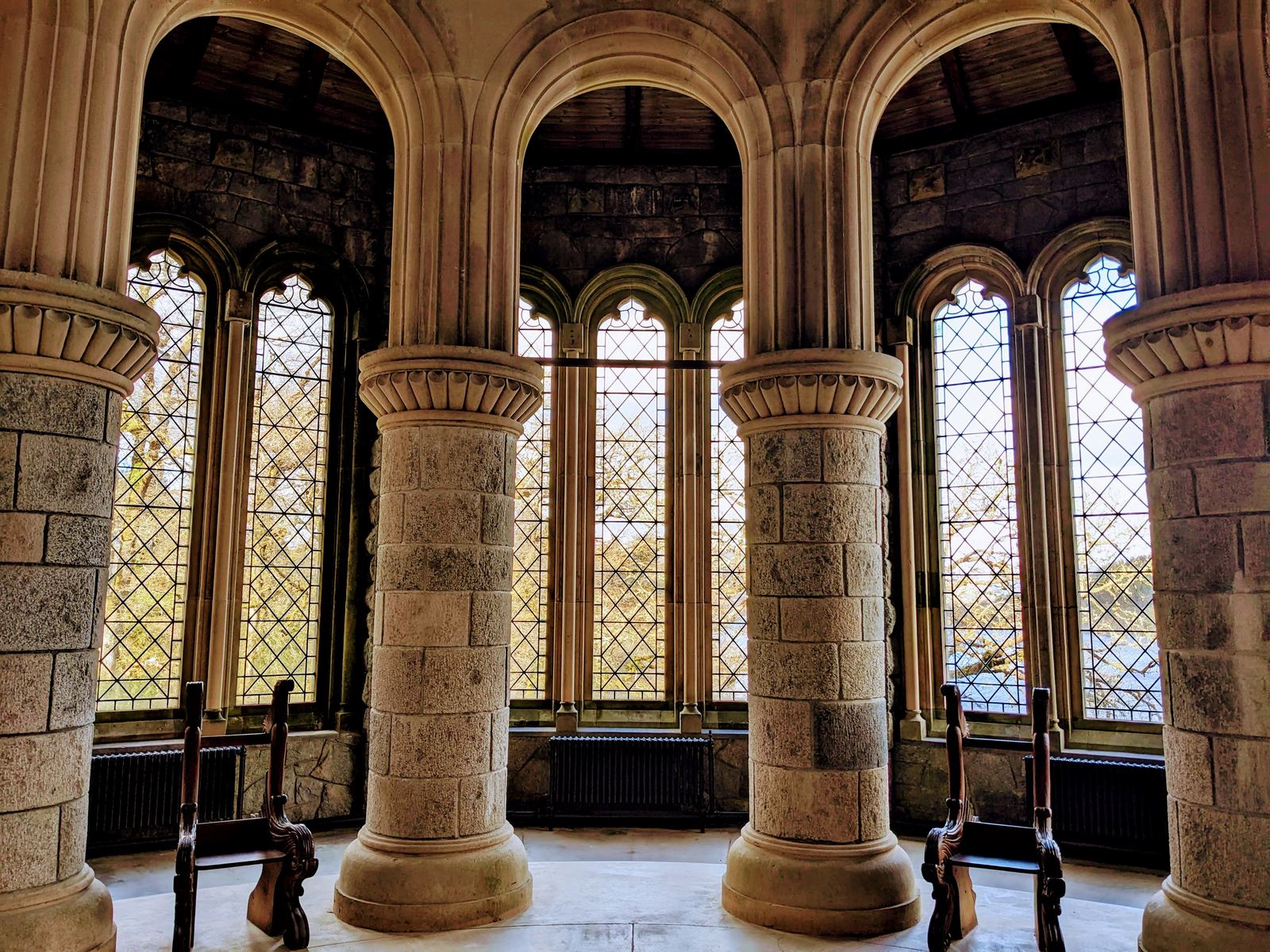 Round stone pillars and leaded windows inside St Conan&rsquo;s Kirk.