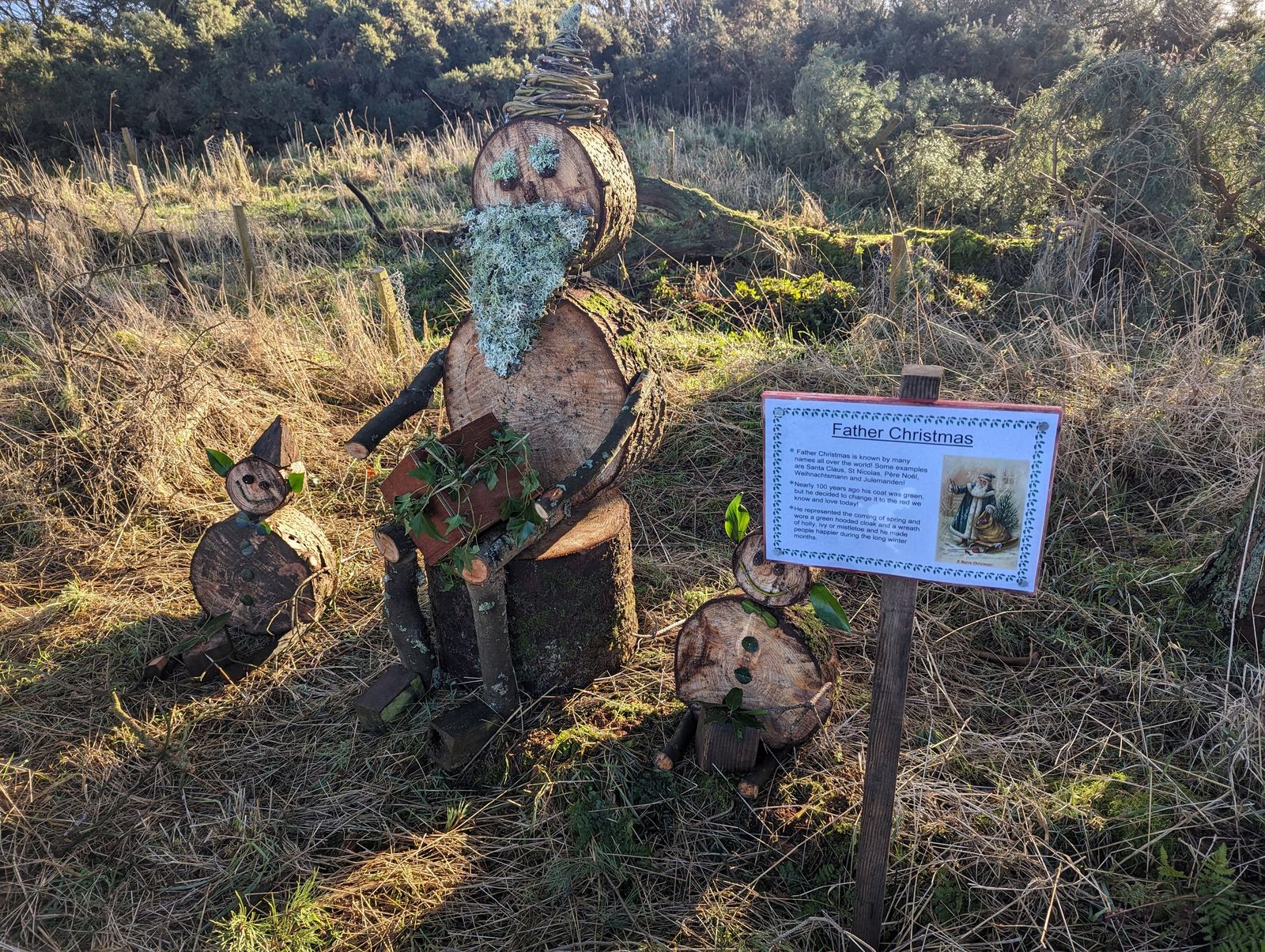 A wooden sculpture and interpretation sign along the Loch Leven trail