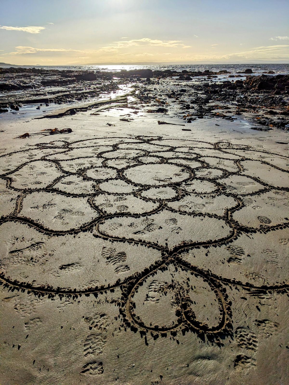 A large heart drawn in the sand on the beach at Lower Largo