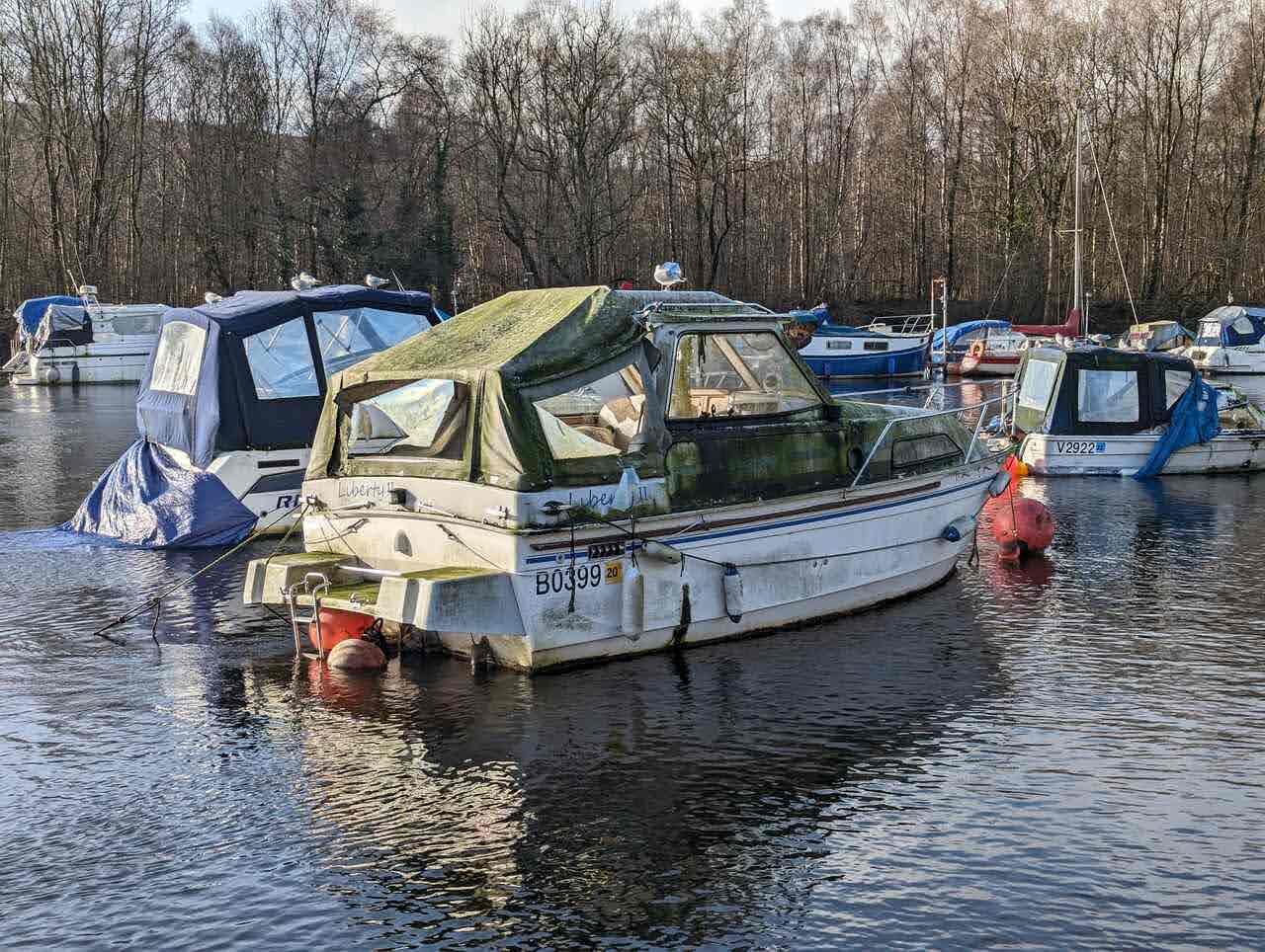 Cabin cruisers and river boats moored on the River Leven at Balloch marina.