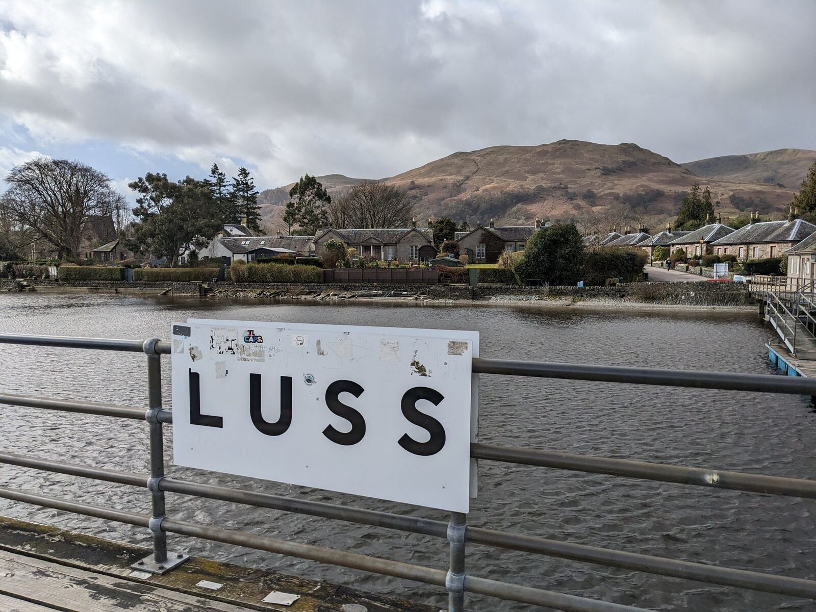 The 'LUSS' village sign by the shore of Loch Lomond.