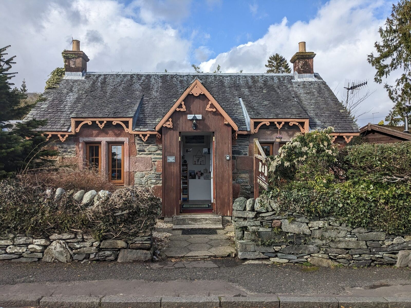 A pretty red-stone cottage in the conservation village of Luss, Loch Lomond.