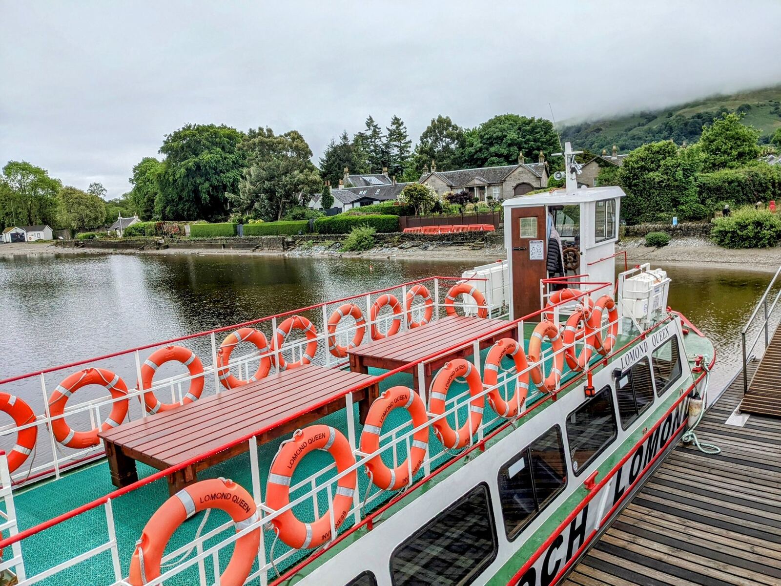 The red and green Maid of the Loch paddle steamer moored at Balloch Pier on Loch Lomond.