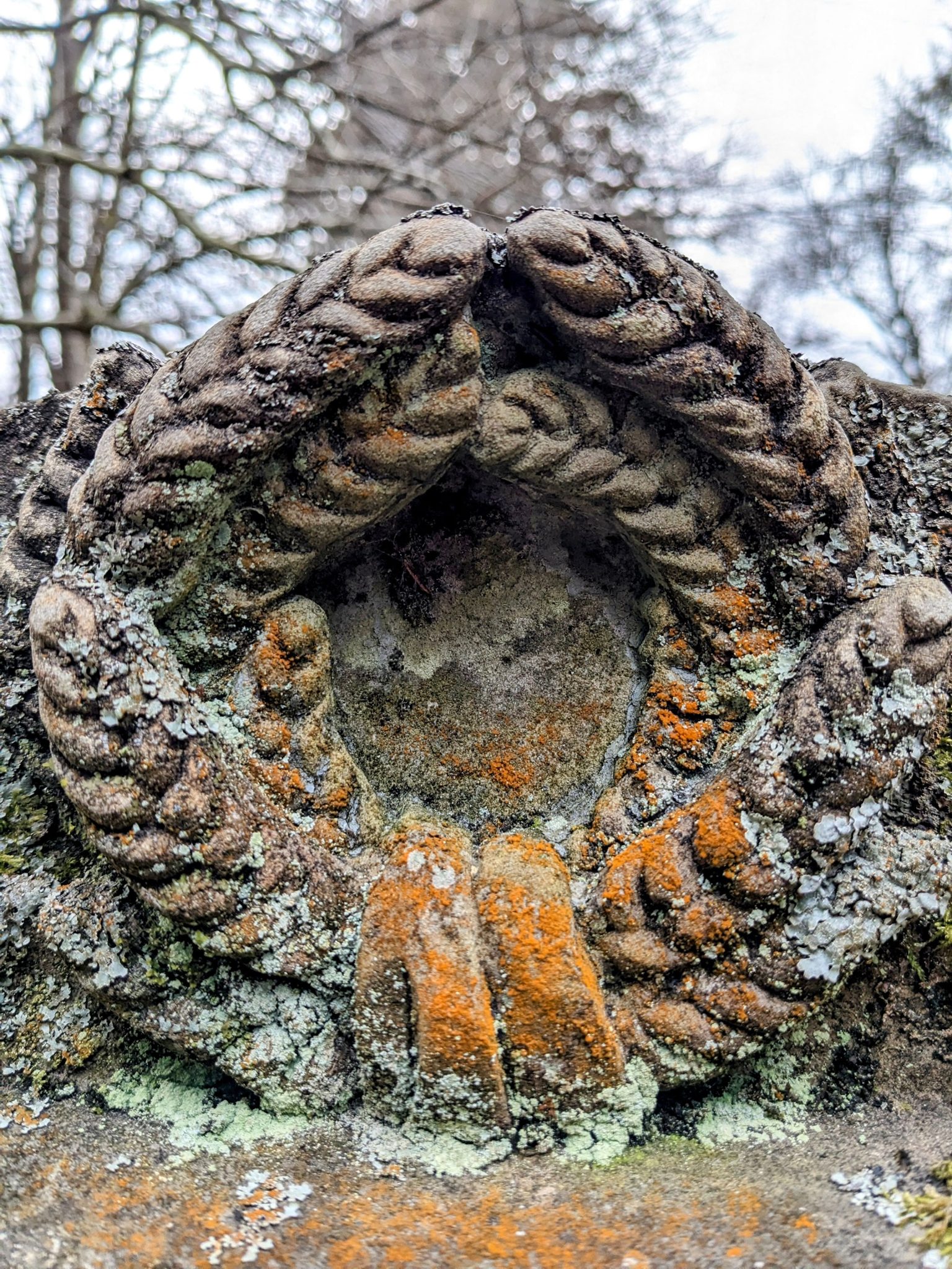 A carved stone wreath and rope detail on an 18th-century tomb at Luss.