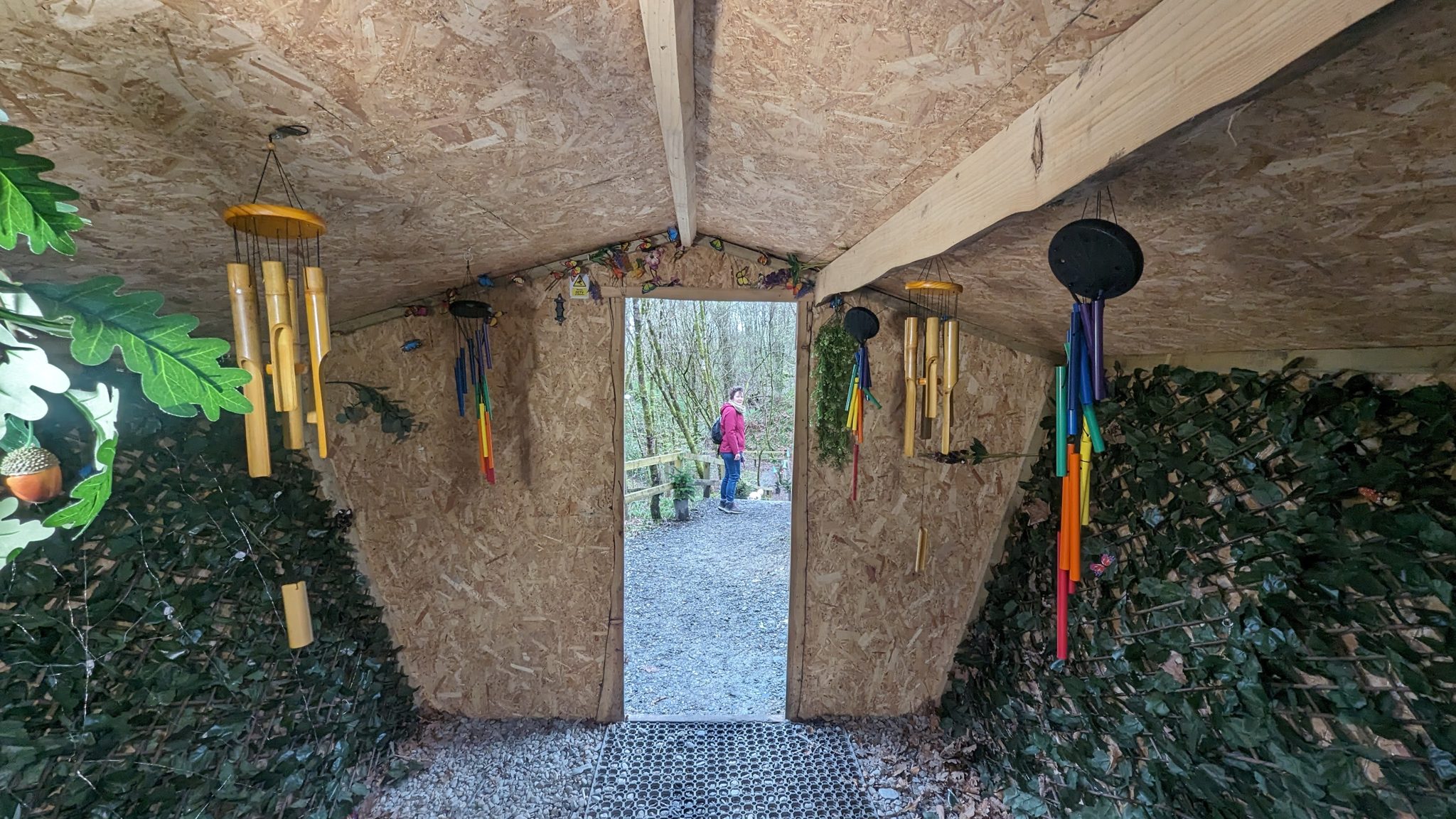 Inside a wooden fairy hut hung with chimes on the Loch Lomond fairy trail at Luss.