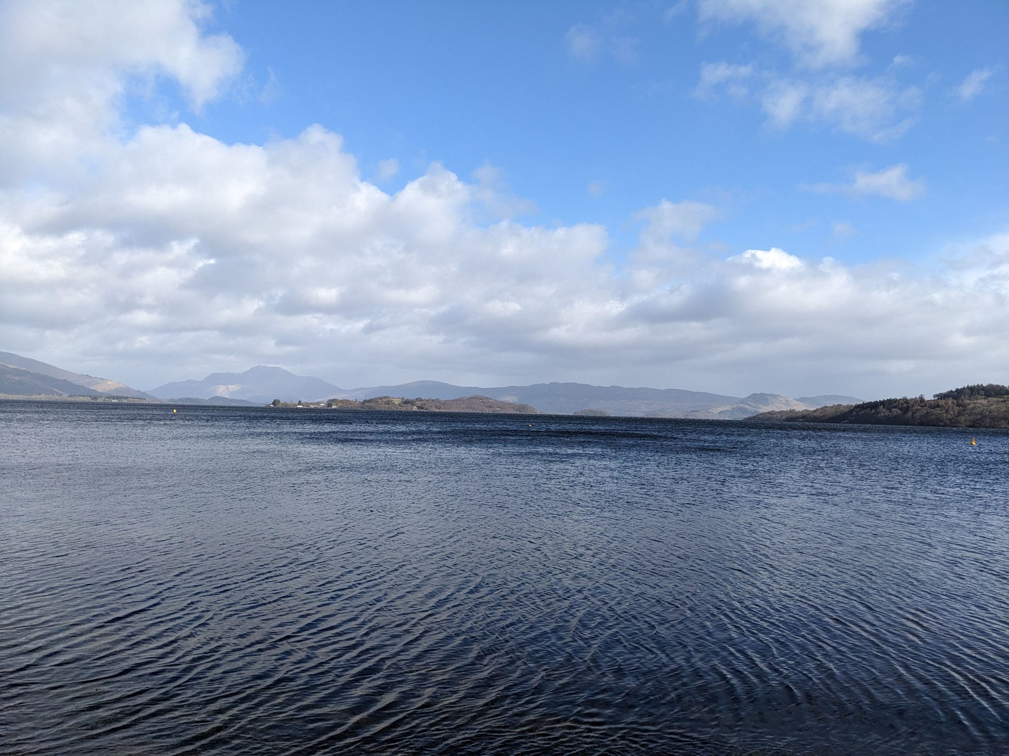 Loch Lomond from Luss looking across the water to Ben Lomond and the hills under a big sky.