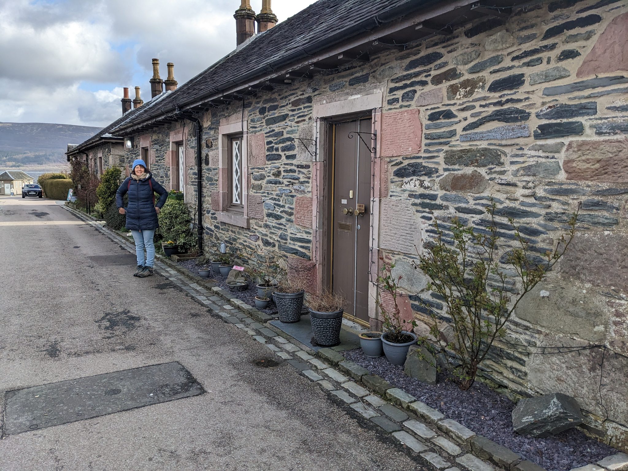 A lane of pink and grey stone cottages at Luss village.