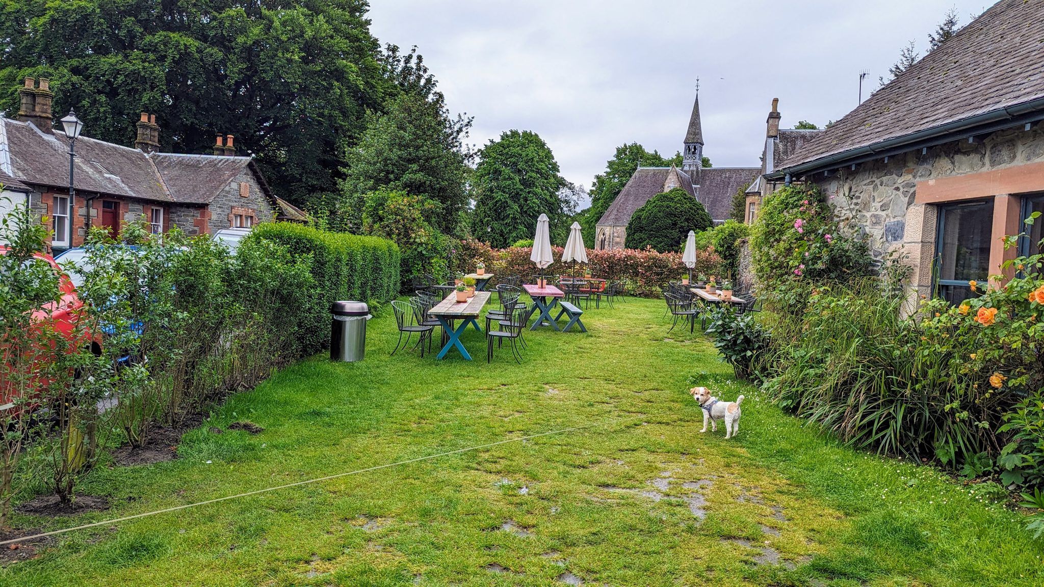 The village green at Luss with the church spire rising behind the cottages.