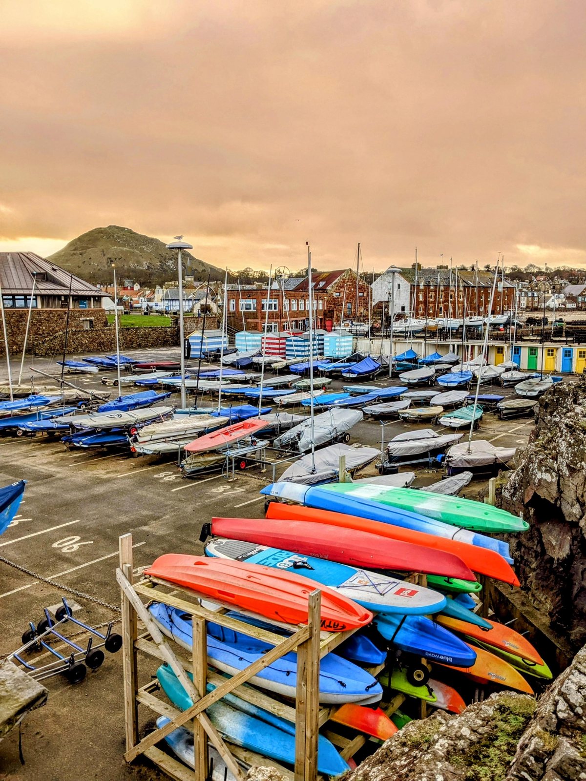 Colourful kayaks by the water at North Berwick harbour.