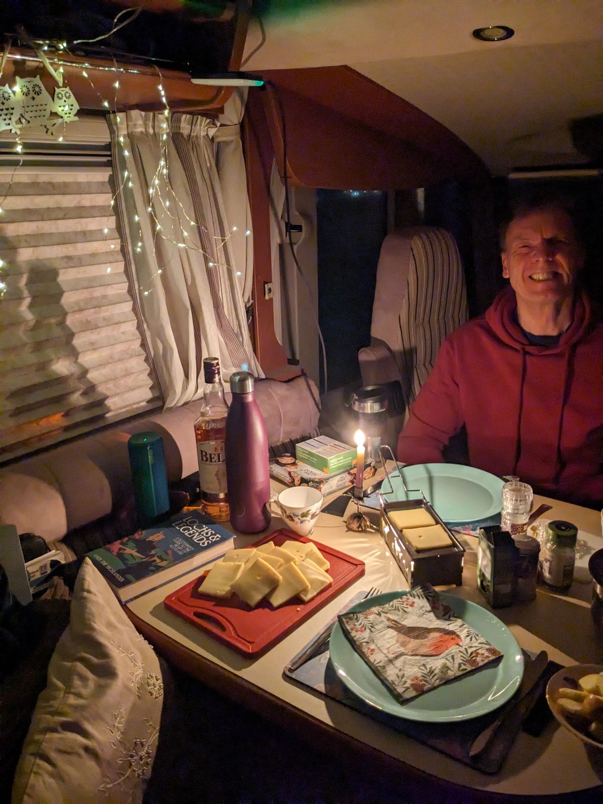 A candlelit dinner laid out on the table inside the motorhome at night at North Berwick.
