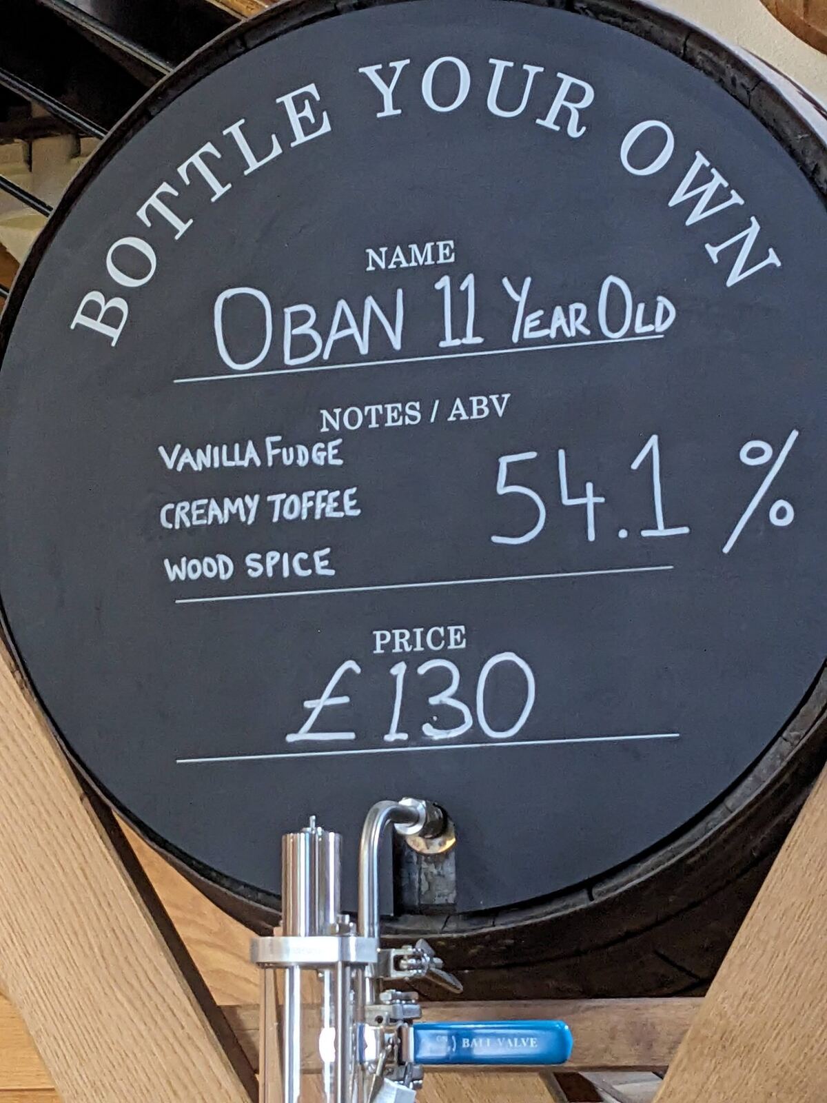 A chalkboard cask at Oban Distillery advertising 'Bottle Your Own' Oban 11 Year Old, 54.1% ABV, £130.