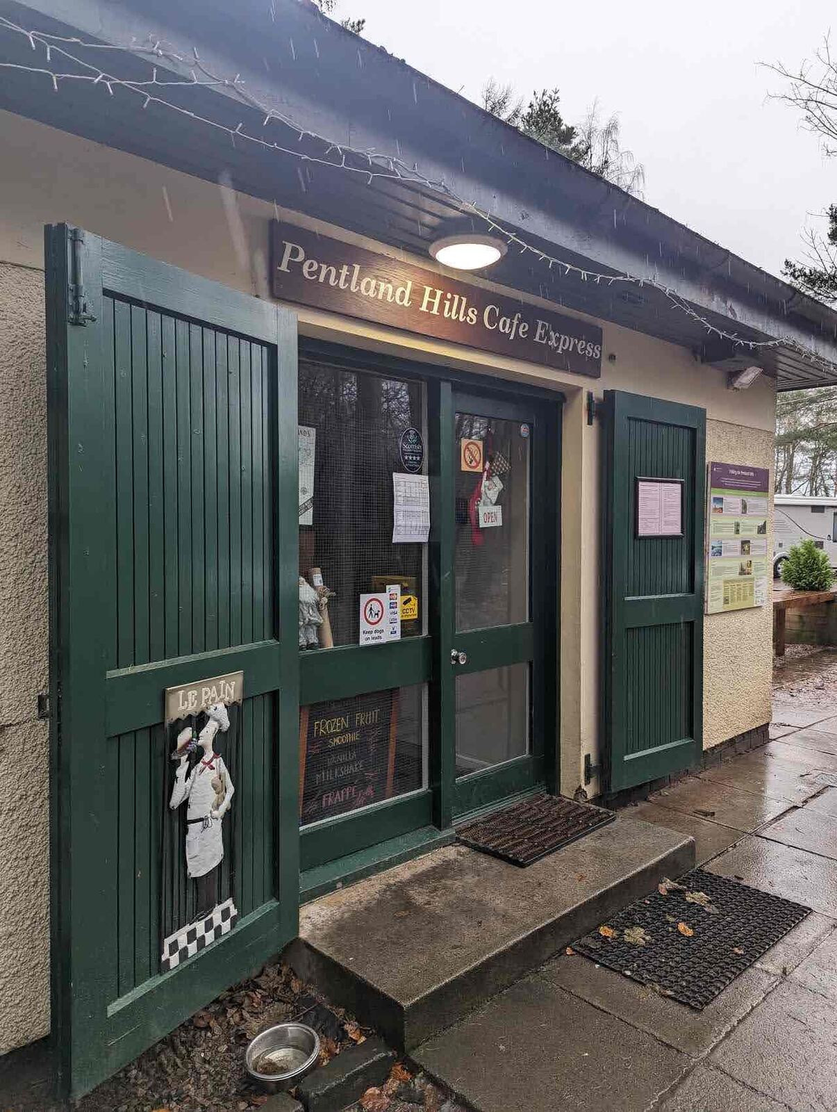 The green-painted Pentland Hills Café Express building at the Flotterstone visitor centre.