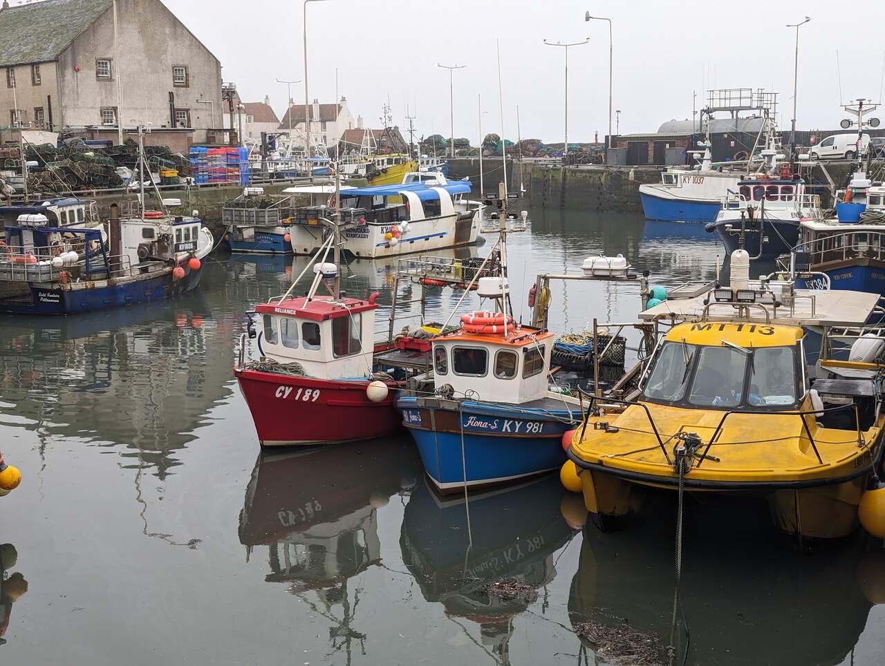 Brightly painted fishing boats along the quay at Pittenweem