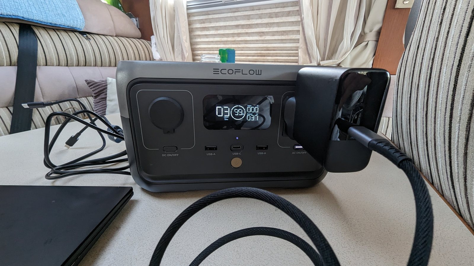 The EcoFlow charging a laptop in the campervan.