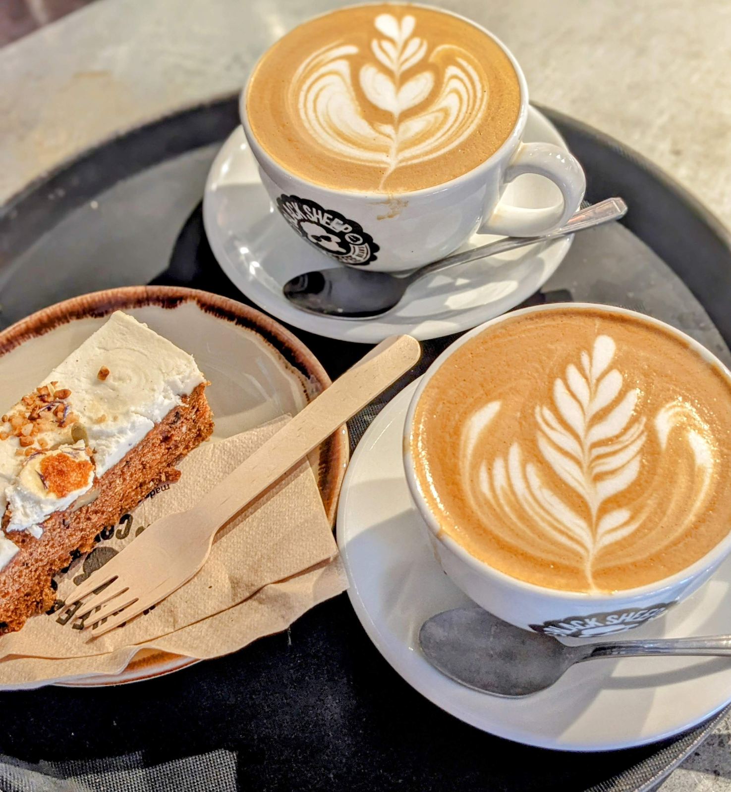 Coffee with latte art and cake at a St Andrews coffee shop.