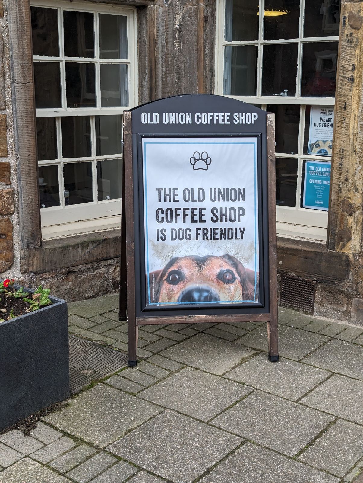 A sign outside the Old Union Coffee Shop in St Andrews reading 'dog friendly'.