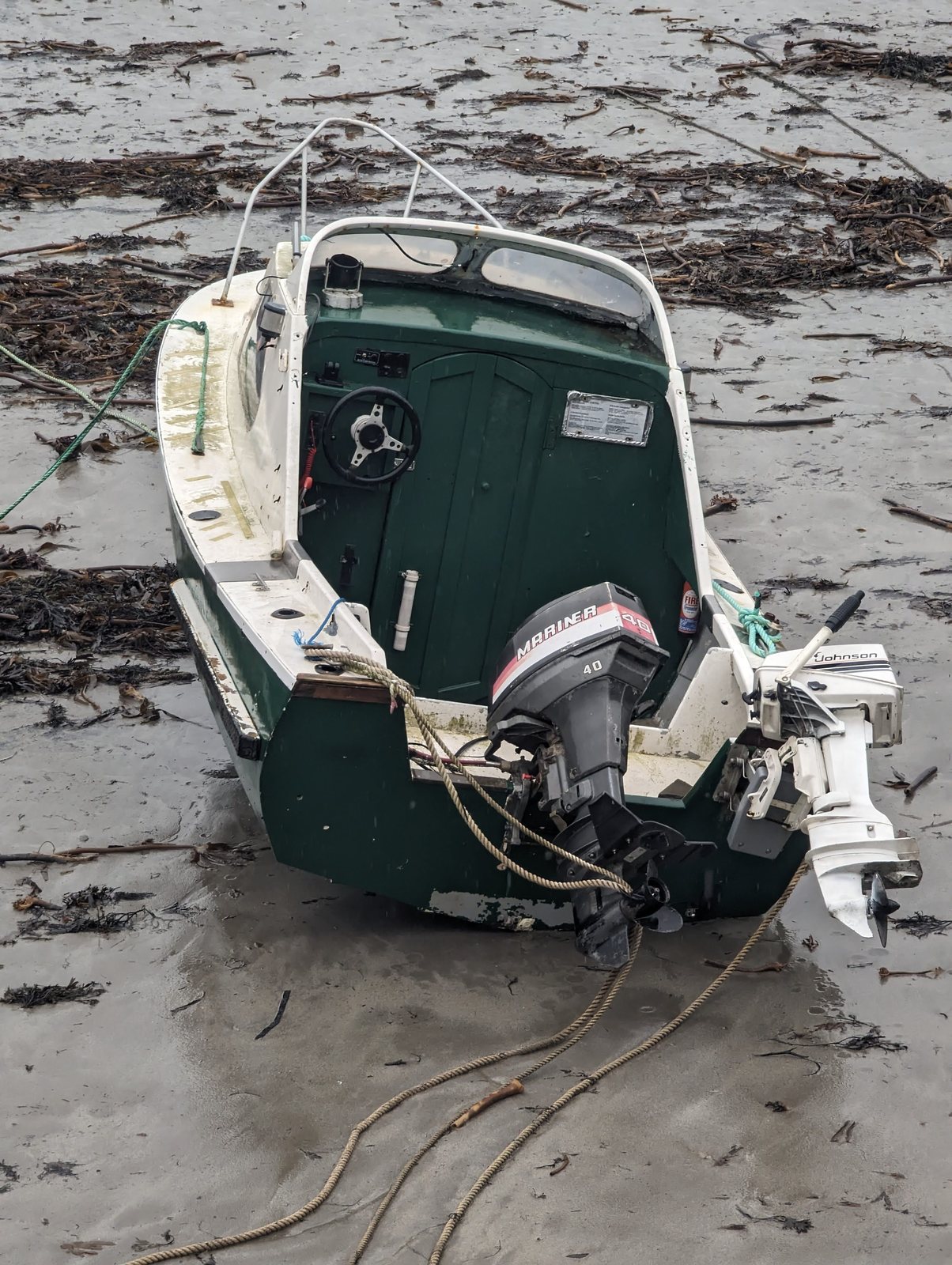 A small boat waiting for the tide on the mud at St Monans harbour.