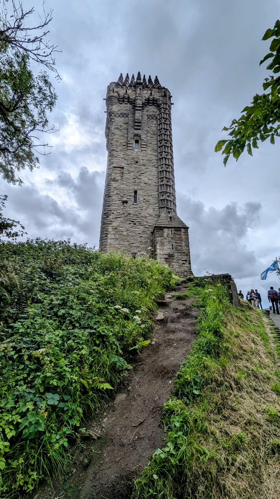 The tall Victorian Gothic tower of the National Wallace Monument rising from the wooded crag of Abbey Craig.
