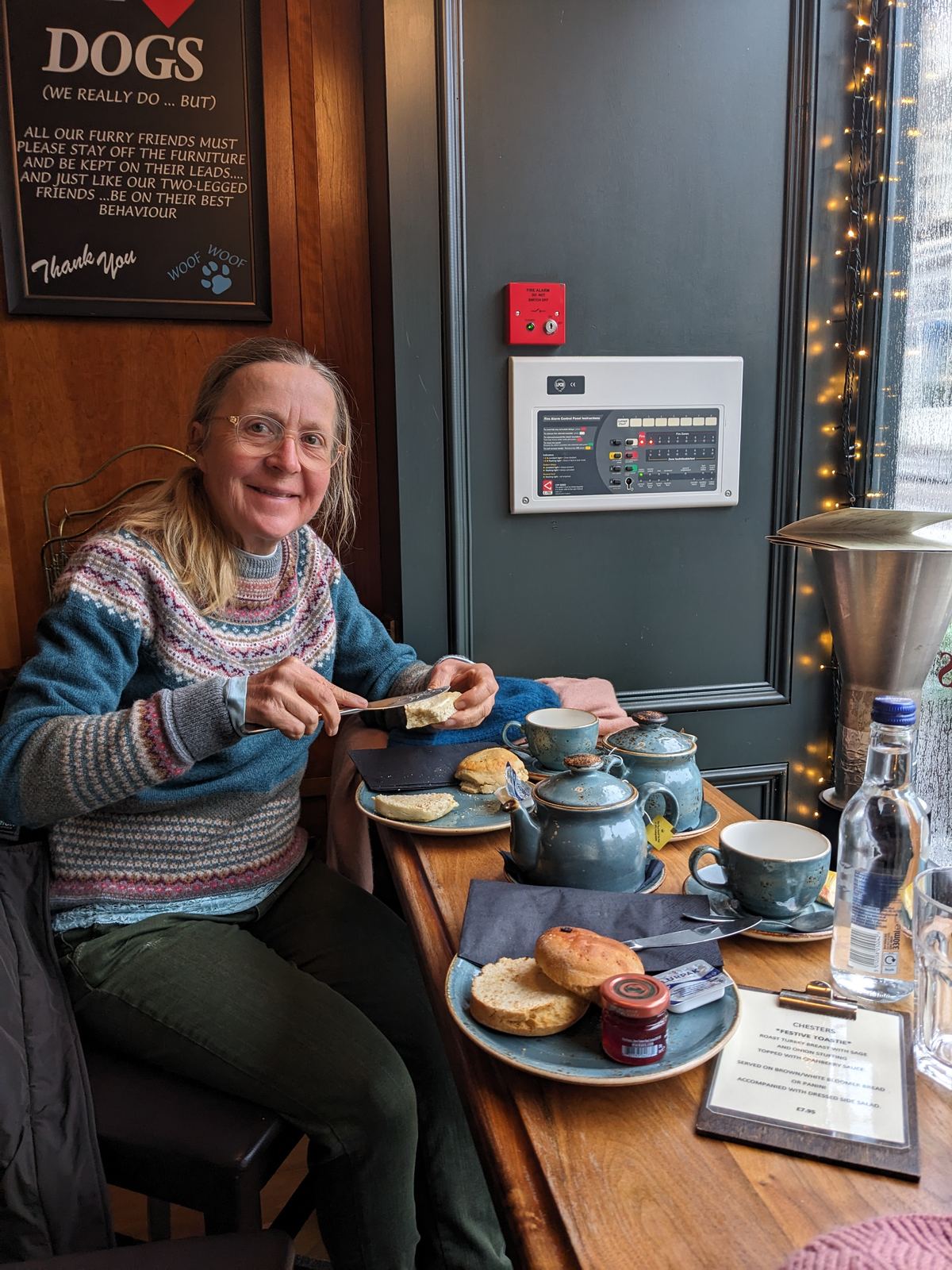A tiered afternoon tea of sandwiches, scones and cakes on a café table in Stirling.