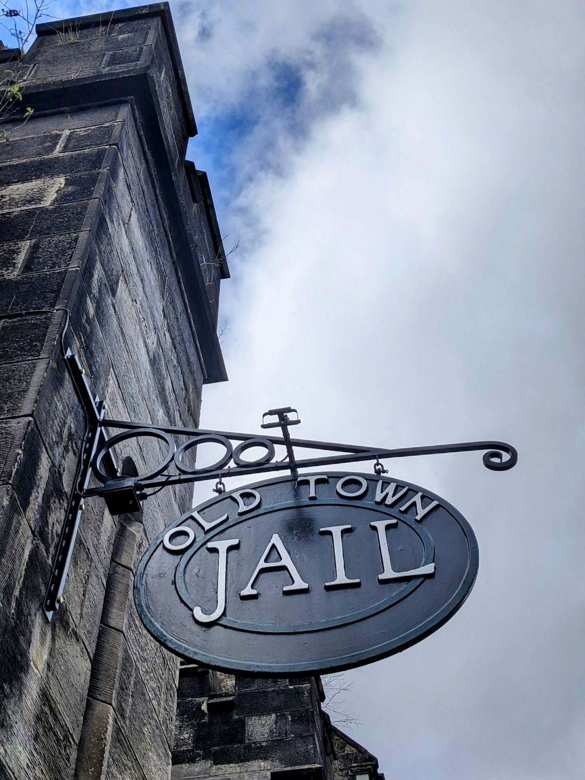 A hanging wrought-iron sign reading 'Old Town Jail' outside the Victorian prison in Stirling.