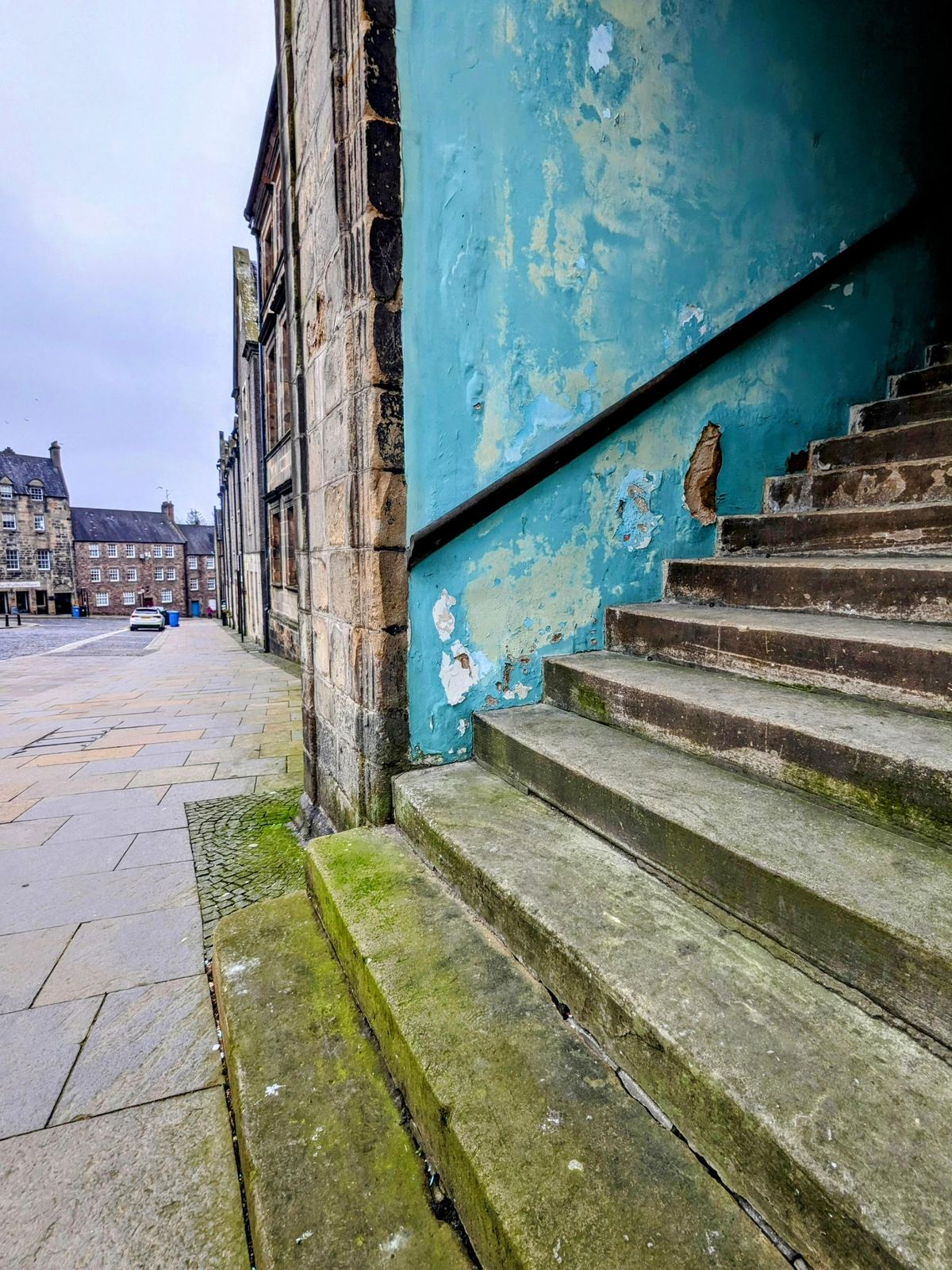 Steep stone steps climbing between old buildings in Stirling's historic old town.