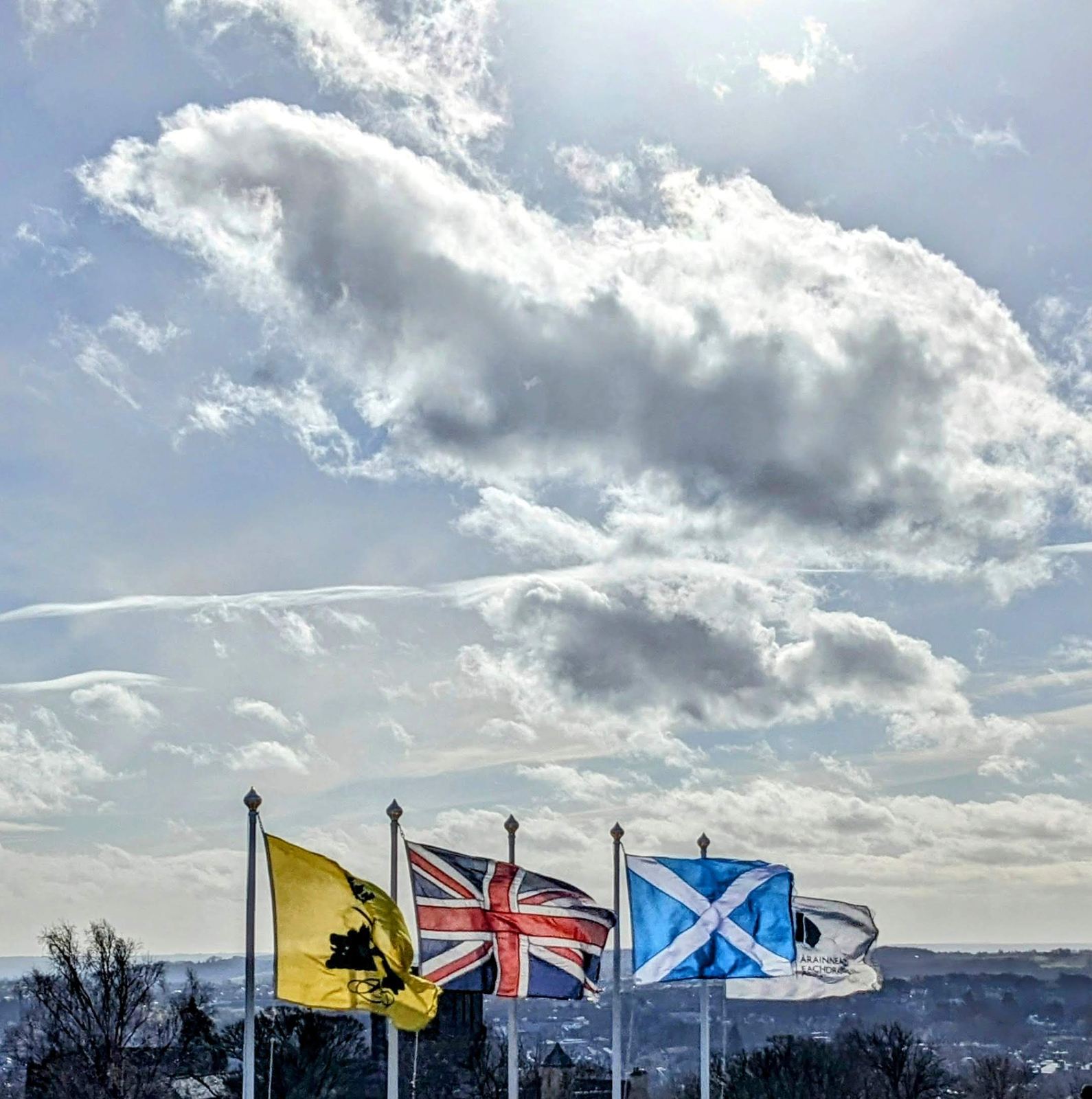 The wide view from Abbey Craig over the carse and the town toward the Ochil Hills under a big sky.