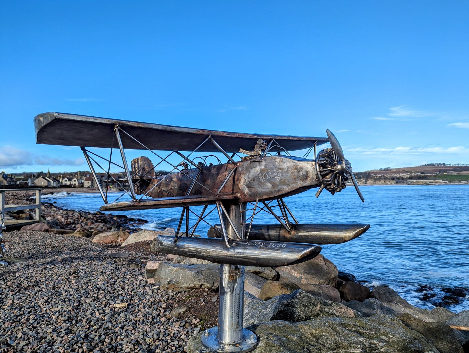 A floatplane sculpture with the town beyond, Stonehaven.