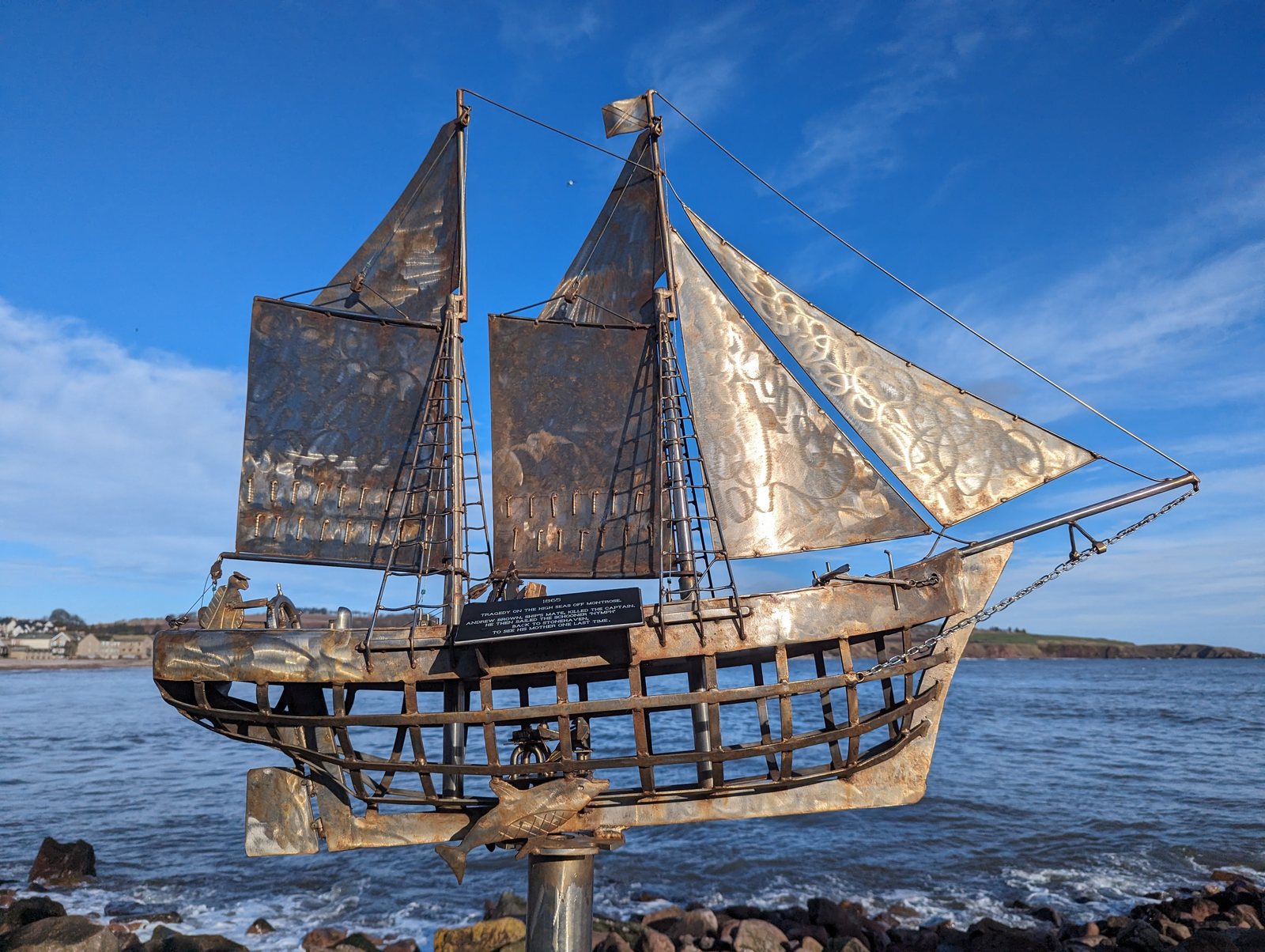 A tall-ship sculpture under a full press of metal sails, Stonehaven.