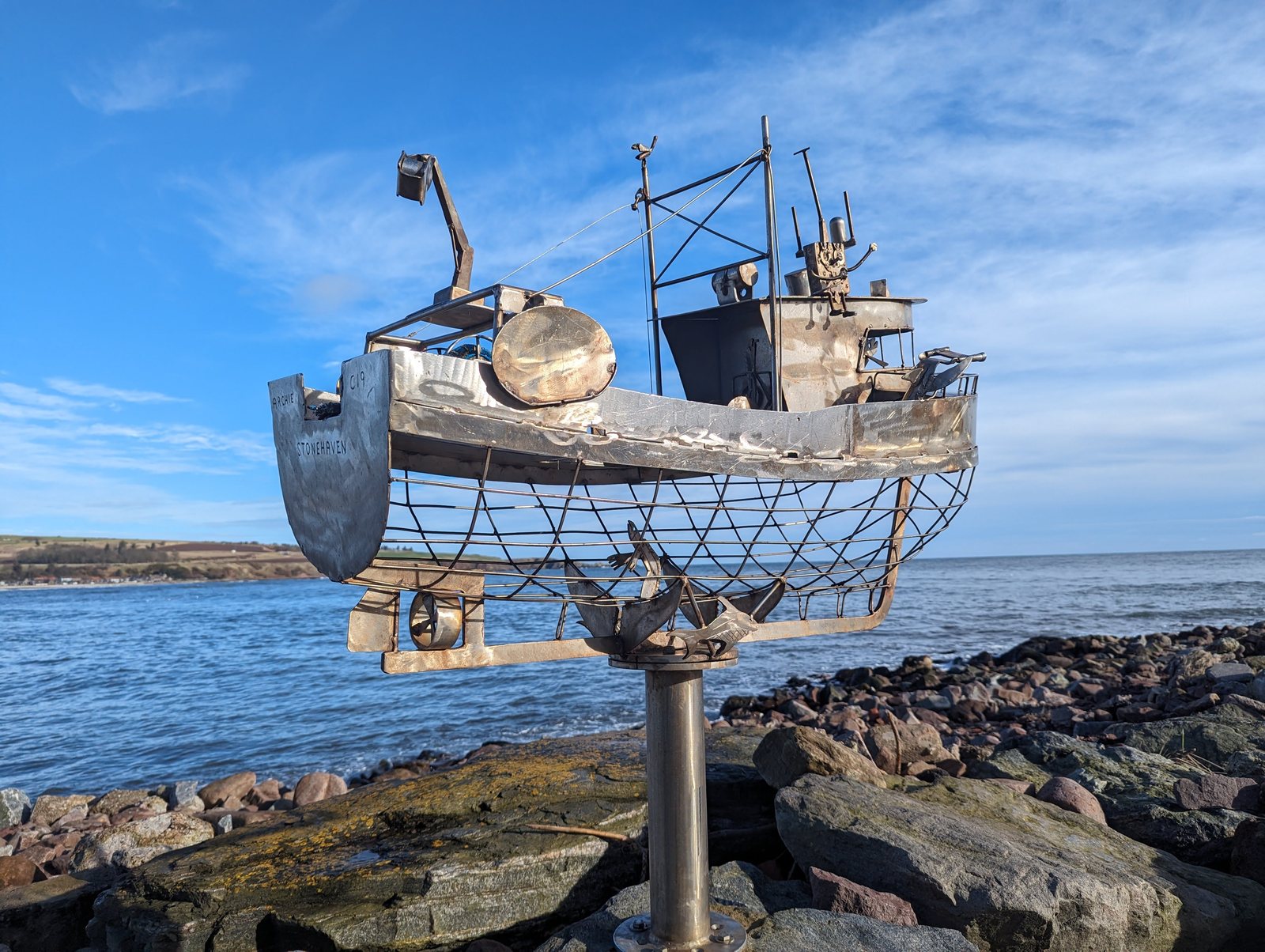 A wire trawler sculpture on the shoreline at Stonehaven.