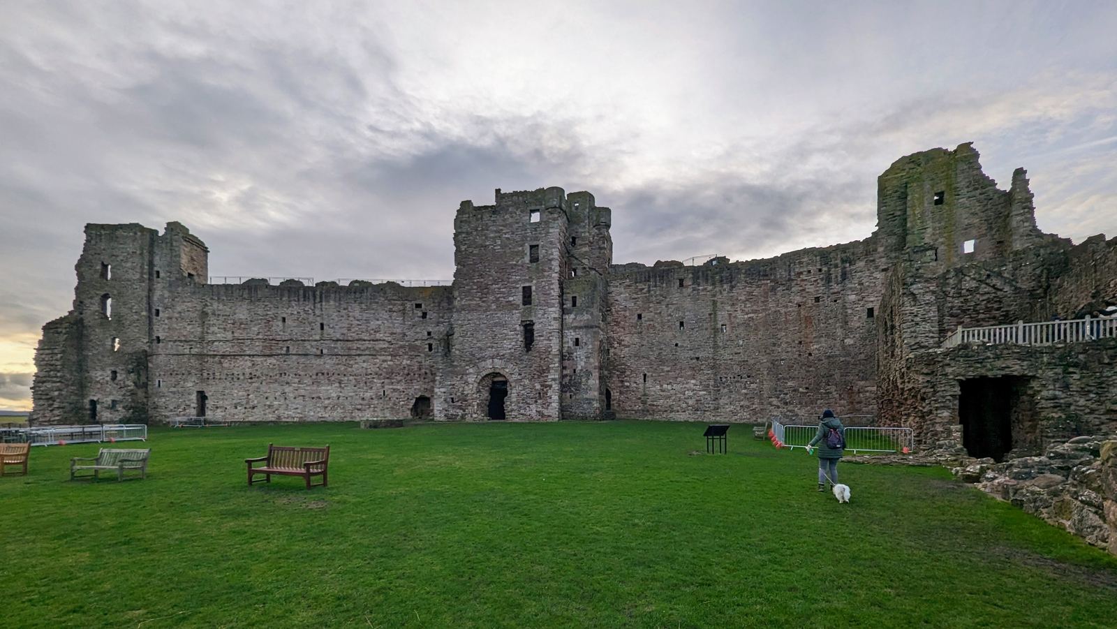 The grassy courtyard of Tantallon Castle ringed by its ruined towers.