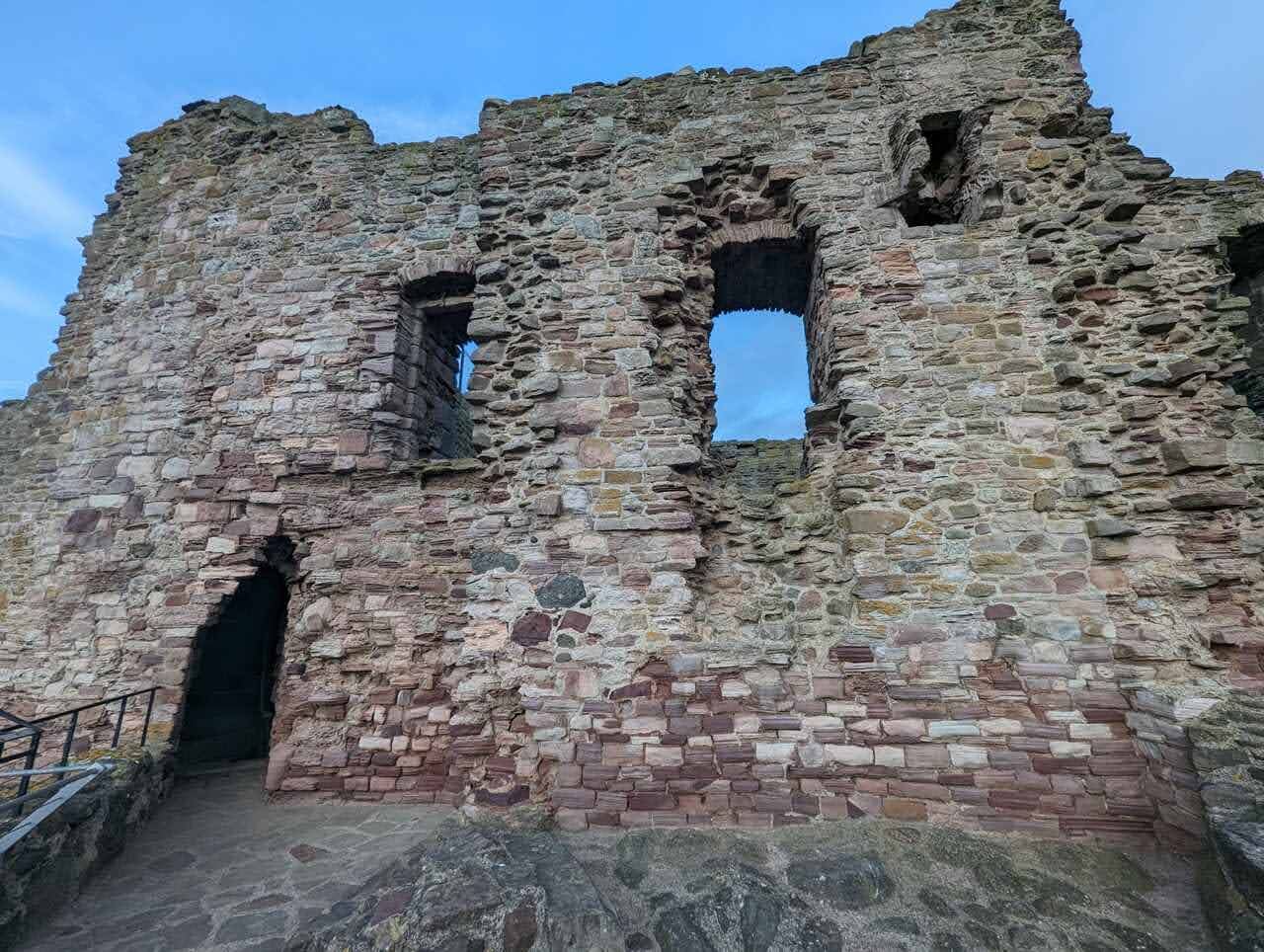 The old stone doocot (dovecot) beside the ruined towers of Tantallon Castle.