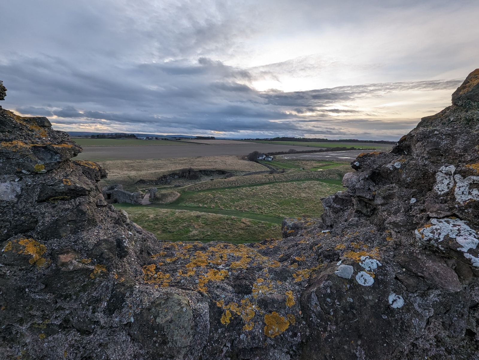 A castle window at Tantallon framing the sea and cliffs beyond.