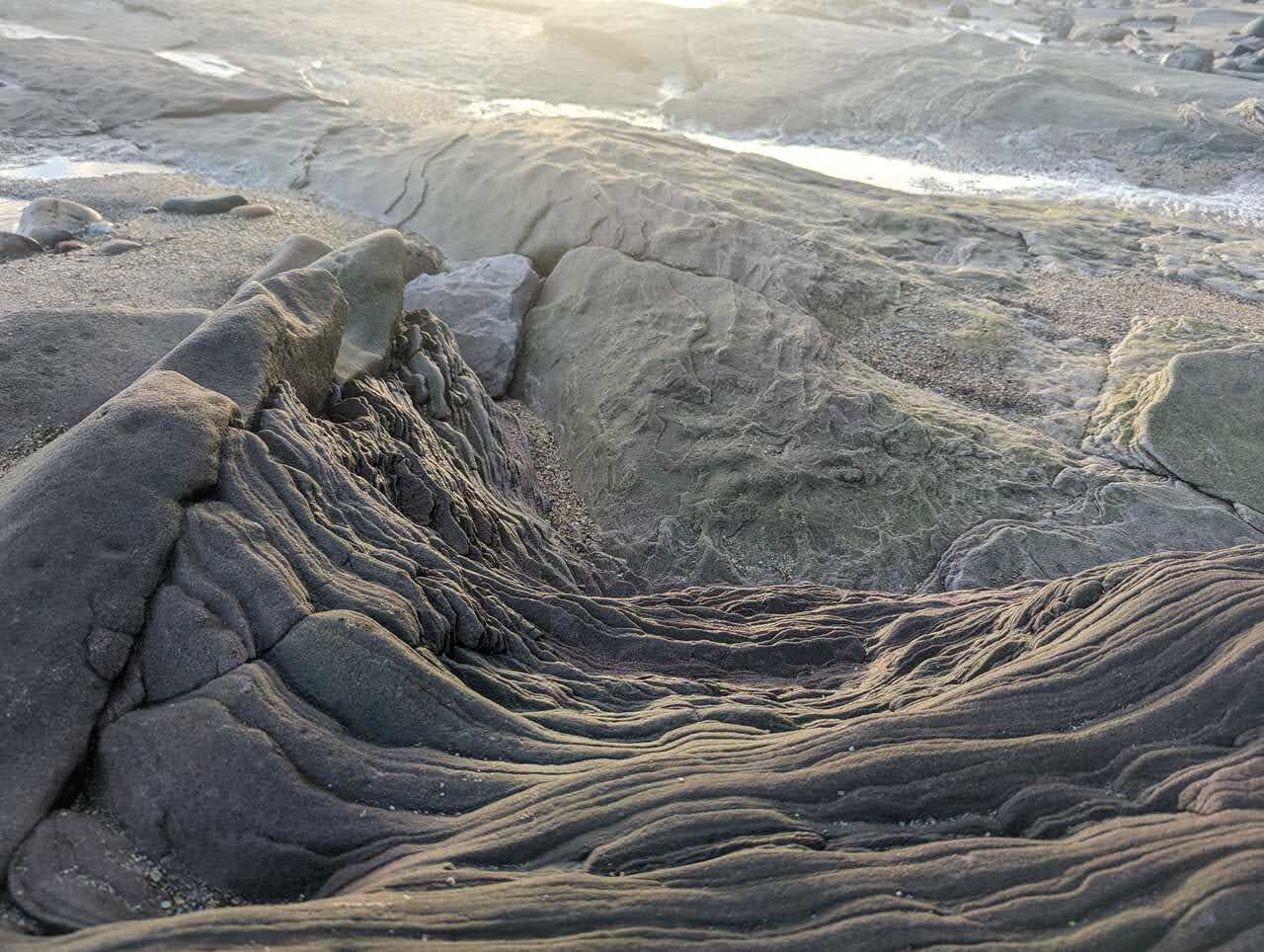 Close detail of the swirling, folded sandstone rock at Tyninghame.
