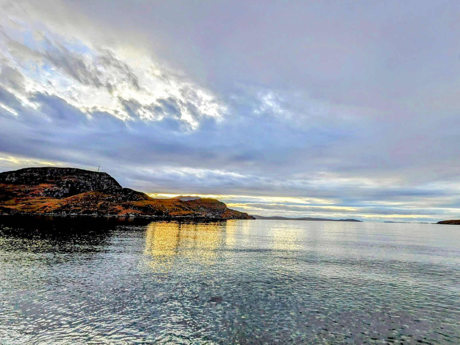The curved shingle beach at Ardmair near Ullapool, with Lillie the dog.
